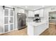Clean modern kitchen with white cabinets, hardwood floors, and stainless steel appliances at 722 Valencia Ave, Orange City, FL 32763