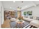 Open concept living room featuring hardwood floors, a bookshelf, and a comfortable sofa at 722 Valencia Ave, Orange City, FL 32763