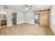 Spacious main bedroom features a ceiling fan, hardwood floors, and sliding barn door at 722 Valencia Ave, Orange City, FL 32763