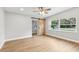 Bright main bedroom with hardwood floors, a ceiling fan, and a sliding barn door at 722 Valencia Ave, Orange City, FL 32763