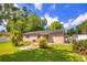 Backyard with grassy lawn, established landscaping, and patio at 741 Greenway Pl, Daytona Beach, FL 32114