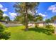 Large backyard with mature trees and green grass at 741 Greenway Pl, Daytona Beach, FL 32114