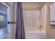 A bright bathroom featuring a shower-tub combination and white fixtures at 741 Greenway Pl, Daytona Beach, FL 32114
