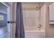 Bathroom with standard tub and shower combination, featuring a shower curtain and towel rack at 741 Greenway Pl, Daytona Beach, FL 32114