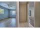 Sun-filled bedrooms with wood-look tile flooring, ceiling fan, and neutral paint at 741 Greenway Pl, Daytona Beach, FL 32114