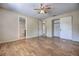 Bedroom with attached bathroom, ceiling fan, and wood-look floors at 741 Greenway Pl, Daytona Beach, FL 32114