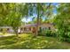 Charming single-story home with a well-kept lawn and mature landscaping, exuding curb appeal at 741 Greenway Pl, Daytona Beach, FL 32114