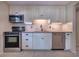 Charming kitchen featuring modern appliances, tile backsplash, and ample cabinet space at 741 Greenway Pl, Daytona Beach, FL 32114