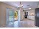 Bright kitchen features tile floor, stainless appliances, and access to backyard through sliding glass door at 741 Greenway Pl, Daytona Beach, FL 32114