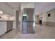 View of a stainless steel refrigerator and an open layout connecting to a living area with fireplace at 741 Greenway Pl, Daytona Beach, FL 32114