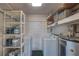 Functional laundry area with shelving, washer, dryer, and water heater at 741 Greenway Pl, Daytona Beach, FL 32114