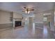 Well-lit living area with a traditional fireplace, tile flooring, and access to dining and kitchen at 741 Greenway Pl, Daytona Beach, FL 32114