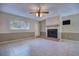 Spacious living room with neutral paint, fireplace, tile floors, and ample natural light at 741 Greenway Pl, Daytona Beach, FL 32114