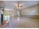 Open-concept living room with fireplace, tile floors, and seamless flow to kitchen and outdoor spaces at 741 Greenway Pl, Daytona Beach, FL 32114