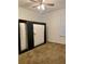 Bedroom with a ceiling fan, carpeted floors, and a murphy bed at 7879 Camlyn Ct, Orlando, FL 32818