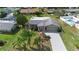 Aerial view of a well maintained home with a long driveway, mature landscaping and a private backyard pool at 826 W Gaucho Cir, Deltona, FL 32725