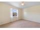 Neutral bedroom with carpet floors, ceiling fan, and window with views of the neighborhood at 826 W Gaucho Cir, Deltona, FL 32725