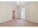 This bedroom features carpet floors, ceiling fan, ensuite bath and access to the exterior at 826 W Gaucho Cir, Deltona, FL 32725