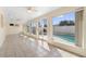 Bright sunroom with tile floors overlooks swimming pool with screened enclosure at 826 W Gaucho Cir, Deltona, FL 32725