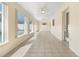 Large, sunny Florida room featuring tile floors, windows and ceiling fans at 826 W Gaucho Cir, Deltona, FL 32725