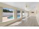 Bright sunroom with tile floors overlooks the swimming pool with screened enclosure at 826 W Gaucho Cir, Deltona, FL 32725