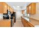 Well-lit kitchen features wood cabinets and modern appliances at 826 W Gaucho Cir, Deltona, FL 32725