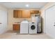 Laundry room with washer, dryer, utility sink, hot water heater and extra storage at 826 W Gaucho Cir, Deltona, FL 32725