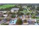 Aerial view of house showing screened pool, solar panels and neighborhood at 980 Buttercup Ter, Deltona, FL 32725