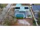 Aerial view of backyard showing screened in pool, solar panels and shed at 980 Buttercup Ter, Deltona, FL 32725