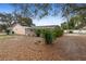 Backyard view of the home with an enclosed pool and lush tropical landscaping at 980 Buttercup Ter, Deltona, FL 32725