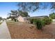 Backyard view of the home with an enclosed pool and lush tropical landscaping at 980 Buttercup Ter, Deltona, FL 32725