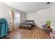 Bright bedroom with wood laminate flooring and a bed with dark floral comforter at 980 Buttercup Ter, Deltona, FL 32725