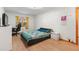 Comfortable bedroom featuring modern furniture, wood laminate flooring, and large window at 980 Buttercup Ter, Deltona, FL 32725