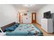 Well-lit bedroom features wood floors, bureau, and a bed with butterfly comforter at 980 Buttercup Ter, Deltona, FL 32725