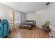 Bright bedroom with wood laminate flooring and a bed with dark floral comforter at 980 Buttercup Ter, Deltona, FL 32725