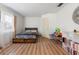 Bright bedroom with wood laminate flooring and a bed with dark floral comforter at 980 Buttercup Ter, Deltona, FL 32725