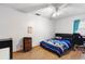 Neutral bedroom features wood floors, ceiling fan, and window with pleated blinds at 980 Buttercup Ter, Deltona, FL 32725