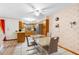 Eat-in kitchen features tile floors, white appliances, and adjacent dining area at 980 Buttercup Ter, Deltona, FL 32725
