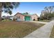 This cozy home boasts a spacious driveway, attached garage, and clean landscaping at 980 Buttercup Ter, Deltona, FL 32725