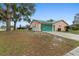 Spacious home featuring an attached garage, clean driveway, and verdant lawn at 980 Buttercup Ter, Deltona, FL 32725