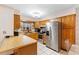 Bright kitchen with wood cabinets, stainless steel appliances, and a window above the sink at 980 Buttercup Ter, Deltona, FL 32725