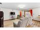 Comfortable living room with plenty of light from sliding glass doors at 980 Buttercup Ter, Deltona, FL 32725