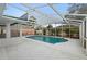 Enclosed pool features a light blue interior, plenty of space and tropical foliage to ensure privacy at 980 Buttercup Ter, Deltona, FL 32725