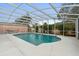 Enclosed pool features a light blue interior, plenty of space and tropical foliage to ensure privacy at 980 Buttercup Ter, Deltona, FL 32725