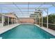 Enclosed pool features a light blue interior, plenty of space and tropical foliage to ensure privacy at 980 Buttercup Ter, Deltona, FL 32725