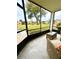 Cozy screened balcony offers views of the lawn, with comfortable seating for outdoor enjoyment at 1000 Lake Of The Woods Blvd # 104F, Casselberry, FL 32730