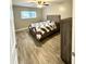 Bedroom featuring wood floors and a double bed with coordinated bedding at 1000 Lake Of The Woods Blvd # 104F, Casselberry, FL 32730