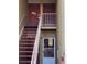 Exterior of a condo building featuring multiple doors and staircases leading to upper-level units at 1000 Lake Of The Woods Blvd # 104F, Casselberry, FL 32730