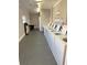 Well-maintained laundry room features multiple washers for residents' convenience, ensuring ease and efficiency at 1000 Lake Of The Woods Blvd # 104F, Casselberry, FL 32730