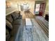 Open living space with hardwood floors, comfortable seating, and a view into the well-equipped kitchen at 1000 Lake Of The Woods Blvd # 104F, Casselberry, FL 32730